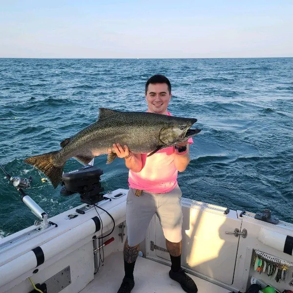 Angler holding up a big king salmon