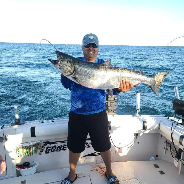 Angler holding a king salmon across his chest