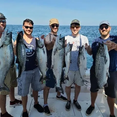 Five friends with a row of salmon